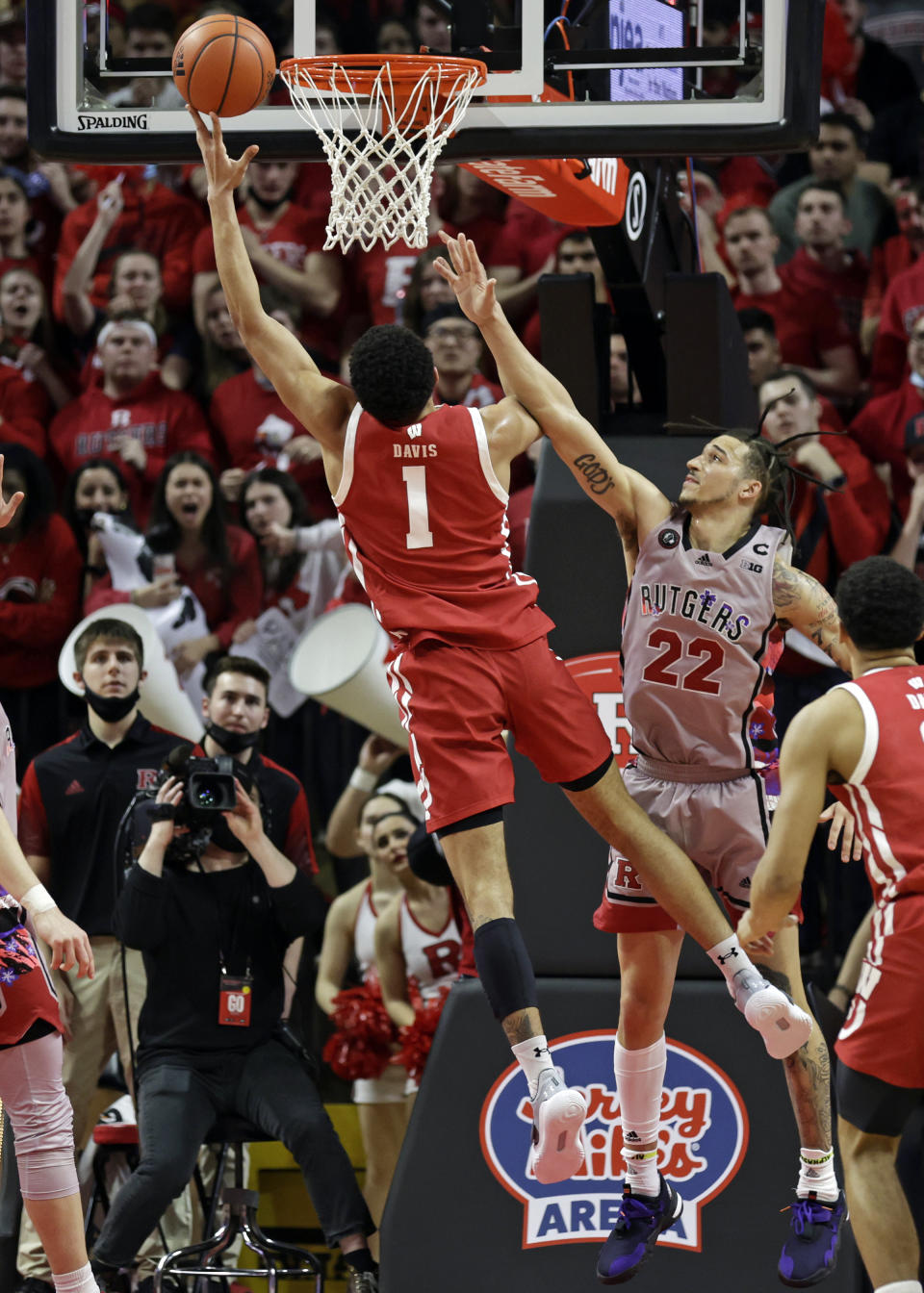 Wisconsin guard Johnny Davis (1) drives to the basket past Rutgers guard Caleb McConnell during the second half of an NCAA college basketball game Saturday, Feb. 26, 2022, in Piscataway, N.J. (AP Photo/Adam Hunger)