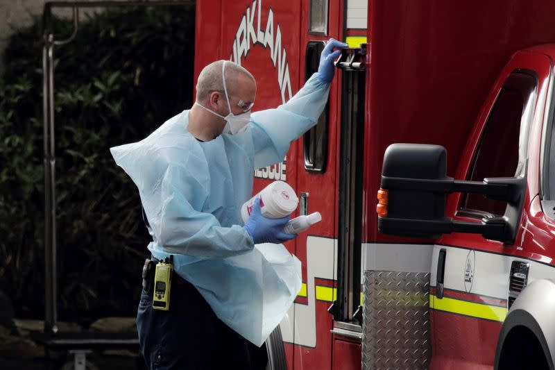 A medic holds disinfecting supplies after transporting a patient into an ambulance at the Life Care Center of Kirkland, the long-term care facility linked to several confirmed coronavirus cases in the state, in Kirkland