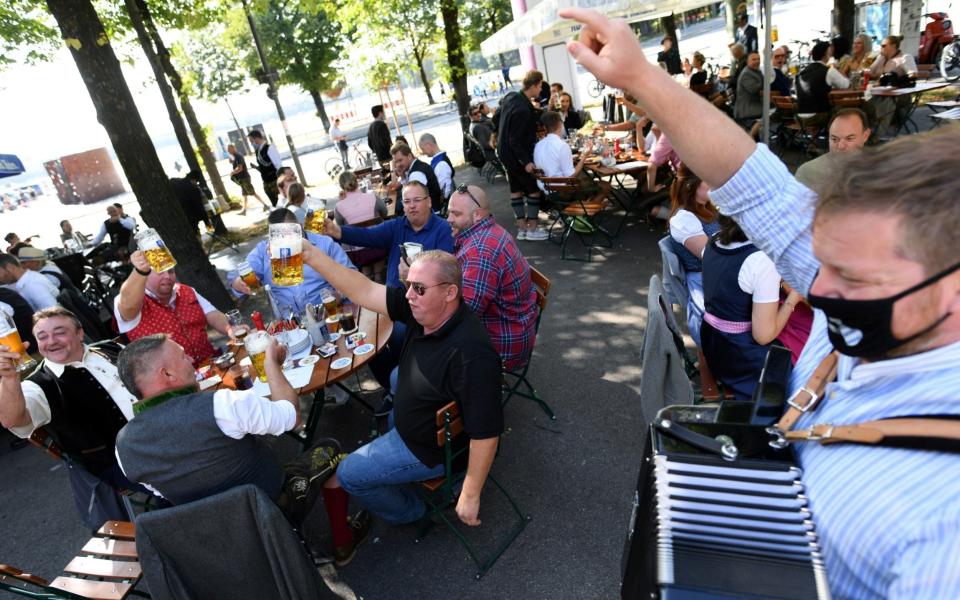 People attend a barrel tapping at a beer garden near Theresienwiese, Munich - REUTERS
