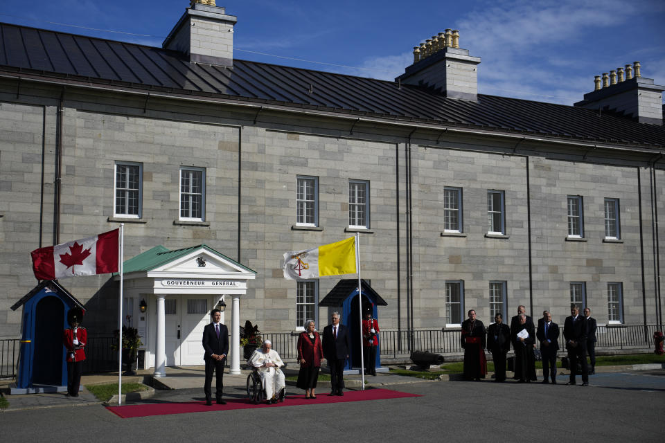 Canadian Prime Minister Justin Trudeau, left, accompanied by Governor-General Mary Simon and her husband Whit Fraser, stand for the Canadian national anthem with Pope Francis at the Citadelle de Quebec, Wednesday, July 27, 2022, in Quebec City, Quebec City, Quebec. Pope Francis is on a "penitential" six-day visit to Canada to beg forgiveness from survivors of the country's residential schools, where Catholic missionaries contributed to the "cultural genocide" of generations of Indigenous children by trying to stamp out their languages, cultures and traditions. (AP Photo/John Locher)