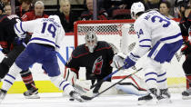 Carolina Hurricanes goaltender Pyotr Kochetkov (52) watches the puck as Toronto Maple Leafs center Calle Jarnkrok (19) and center Auston Matthews (34) look for a shot during the second period of an NHL hockey game Saturday, March 25, 2023, in Raleigh, N.C. (AP Photo/Chris Seward)