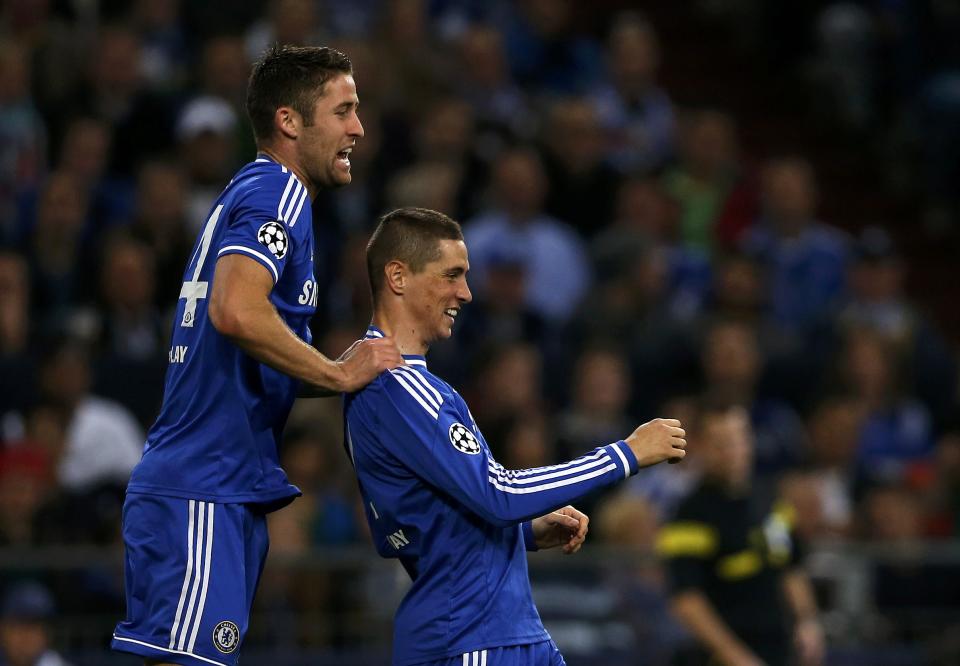 Chelsea's Fernando Torres (R) celebrates with his team mate Gary Cahill after scoring a goal against Schalke 04 during their Champions League soccer match in Gelsenkirchen October 22, 2013. REUTERS/Wolfgang Rattay (GERMANY - Tags: SPORT SOCCER)