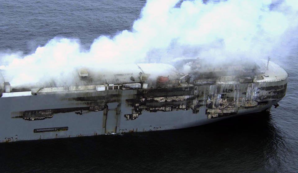 Smoke is seen from a freight ship in the North Sea, about 27 kilometers (17 miles) north of the Dutch island of Ameland, Friday, July 28, 2023. Salvage crews were waiting Friday for a chance to board a cargo ship loaded with cars that has been burning for more than two days off the northern Dutch coast. (Kustwacht Nederland/Coast Guard Netherlands via AP)