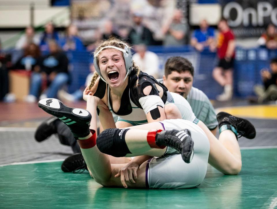 West Salem’s Reese Lawson reacts after pinning her opponent, Redmond’s Kira Gregory, in the OSAA 6A/5A state championship match on Saturday, Feb. 24, 2024 at Veterans Memorial Coliseum in Portland, Ore.