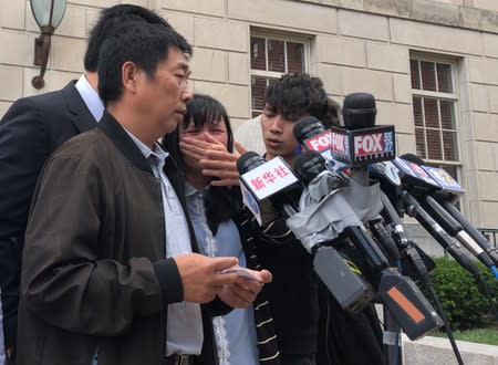 Ronggao Zhang reads a statement outside U.S. District court in Peoria, Illinois