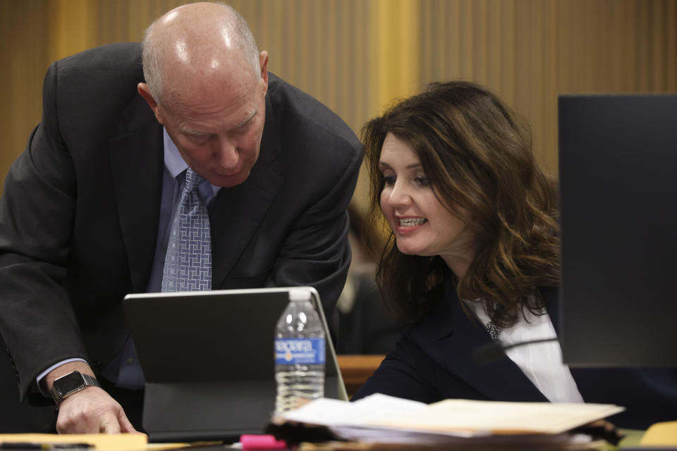 Steve Sadow, former President Donald Trump’s lead attorney in the case, and attorney Anna Cross, who represents the Fulton County District Attorney's Office, look over evidence that is presented by Sadow, during a hearing on the Georgia election interference case, Friday, Feb. 16, 2024, in Atlanta. The hearing is to determine whether Fulton County District Attorney Fani Willis should be removed from the case because of a relationship with Wade, special prosecutor, she hired in the election interference case against former President Donald Trump. (Alyssa Pointer/Pool Photo via AP)