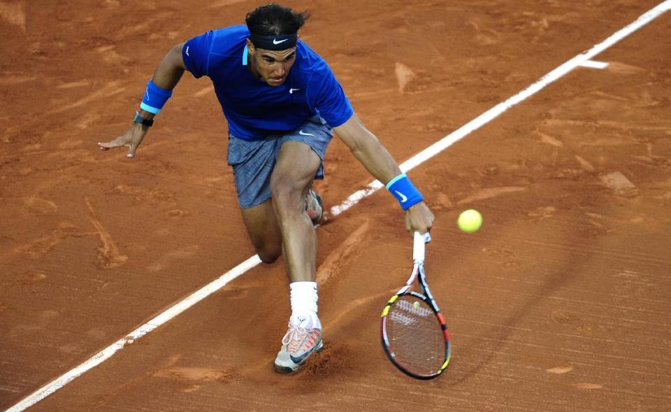 Rafael Nadal of Spain returns the ball to Ivan Dodig from Croatia, during the Barcelona open tennis in Barcelona, Spain, Thursday, April 24, 2014. (AP Photo/Manu Fernandez)