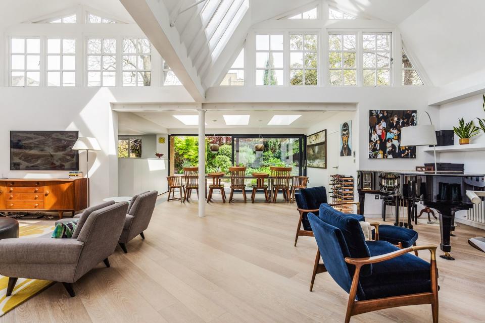 a large room with a piano and chairs