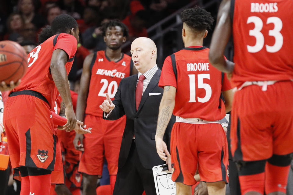 Cincinnati head coach Mick Cronin, center, directs his players in the first half of an NCAA college basketball game against Houston, Sunday, March 10, 2019, in Cincinnati. (AP Photo/John Minchillo)