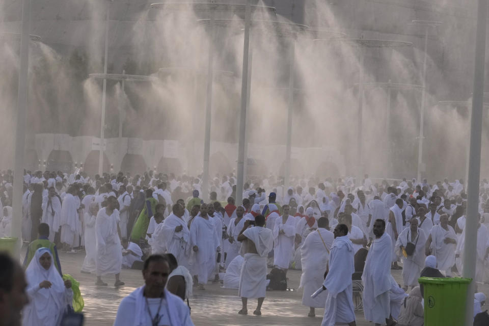 Water is sprayed on Muslim pilgrims at the rocky hill known as the Mountain of Mercy, on the Plain of Arafat, during the annual Hajj pilgrimage, near the holy city of Mecca, Saudi Arabi, Saturday, June 15, 2024. Masses of Muslims gathered at the sacred hill of Mount Arafat in Saudi Arabia for worship and reflection on the second day of the Hajj pilgrimage. The ritual at Mount Arafat, known as the hill of mercy, is considered the peak of the Hajj. It's often the most memorable event for pilgrims, who stand shoulder to shoulder, asking God for mercy, blessings, prosperity and good health. Hajj is one of the largest religious gatherings on earth.(AP Photo/Rafiq Maqbool)
