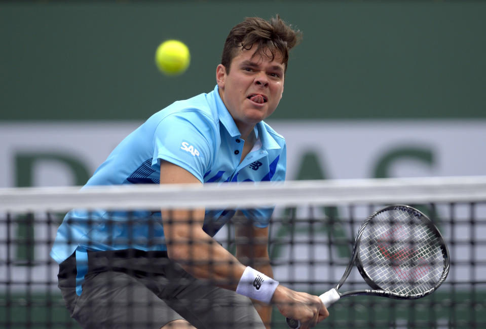 Milos Raonic, of Canada, hits to Alexandr Dolgopolov, of Ukraine, during a quarterfinal at the BNP Paribas Open tennis tournament, Thursday, March 13, 2014, in Indian Wells, Calif. (AP Photo/Mark J. Terrill)