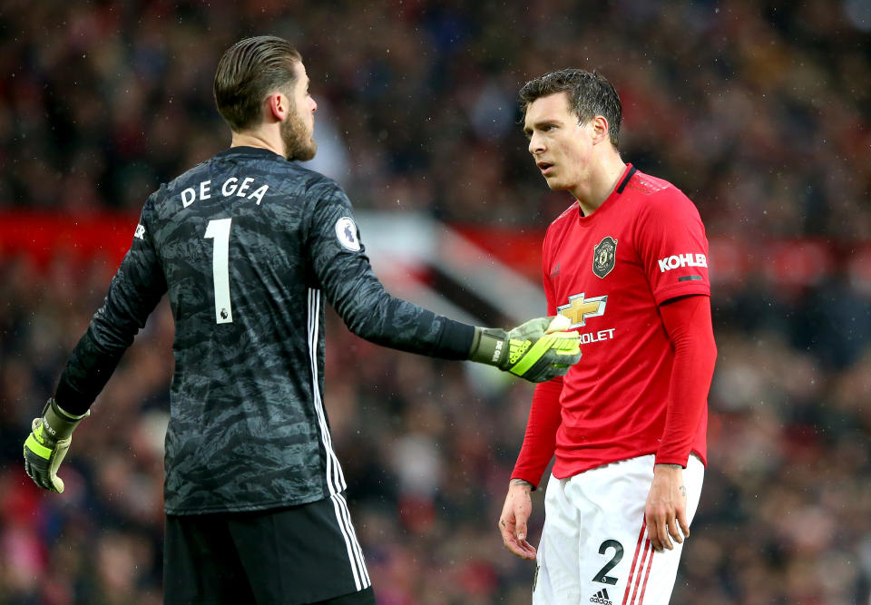 Victor Lindelof of Manchester United reacts with teammate David De Gea after scoring an own goal. (Credit: Getty Images)