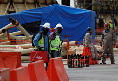 Employees walk a part of the terminal area at the construction site of the new Mexico City International Airport in Texcoco on the outskirts of Mexico City, Mexico October 29, 2018. REUTERS/Henry Romero