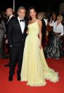 <p>For the screening of <em>Money Monster</em> at the 69th annual Cannes Film Festival, the Clooneys walked the red carpet in style. Amal's one-shoulder yellow chiffon gown and Cartier earrings were perfect for the occasion.</p>