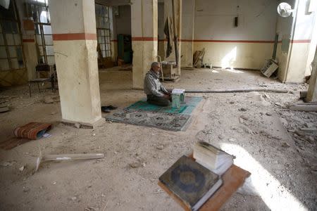 A man is seen inside a damaged mosque in the besieged town of Douma in eastern Ghouta in Damascus, Syria, March 1, 2018. REUTERS/ Bassam Khabieh