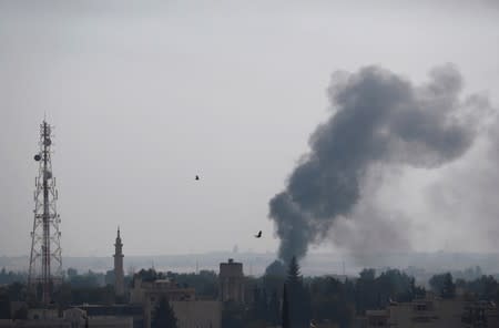 Smoke rises over the Syrian town of Ras al-Ain, as seen from the Turkish border town of Ceylanpinar, Sanliurfa province