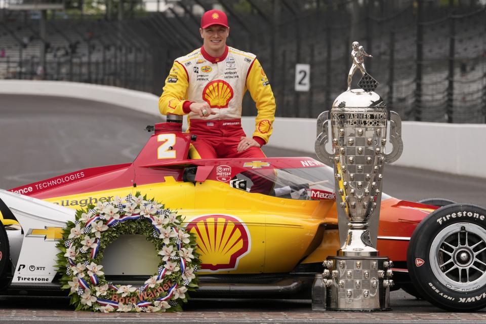 Josef Newgarden poses with the Borg-Warner Trophy during the traditional winners photo session at Indianapolis Motor Speedway, Monday, May 27, 2024, in Indianapolis. Newgarden won the 108th running of the Indianapolis 500 auto race Sunday. (AP Photo/Darron Cummings)