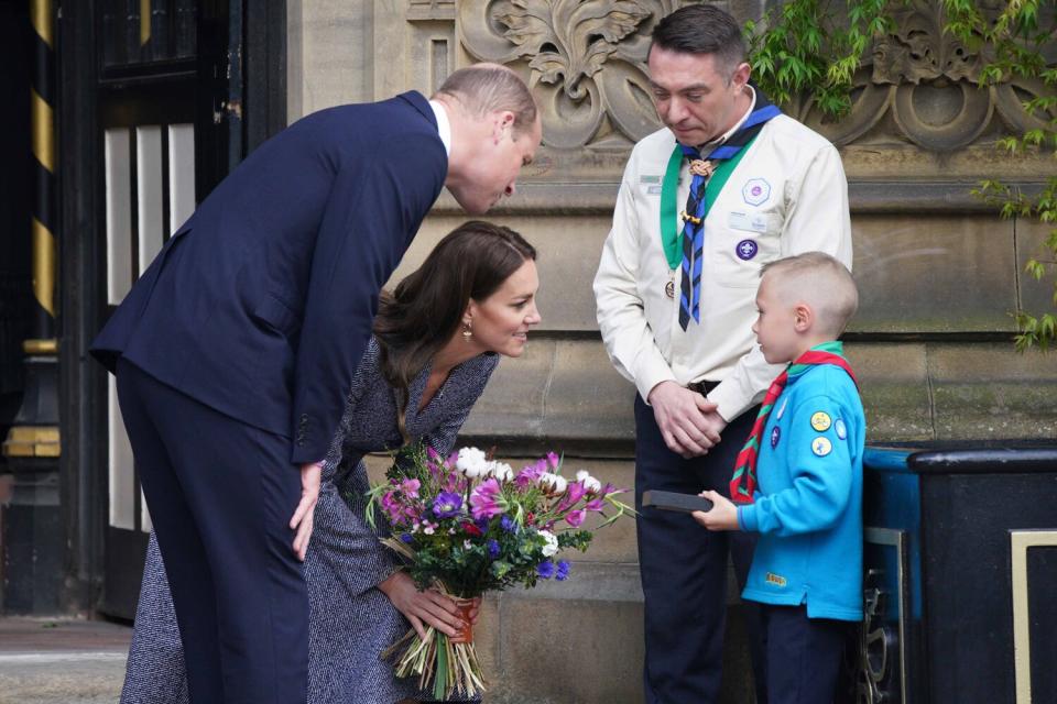 The Duke and Duchess of Cambridge speak to Archie McWilliams, aged 7, from the First Longford Scout Group in Stretford, and his uncle Greater Manchester West Scouts' County Commissioner Andy Farrell, as they leave after attending the official opening of the Glade of Light Memorial