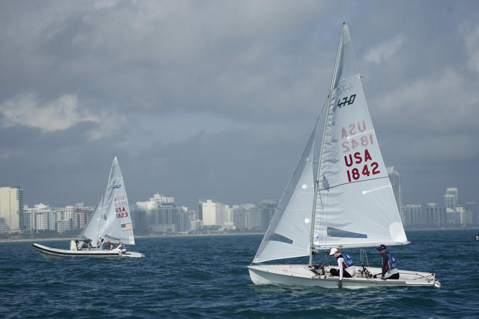 Lara Dallman-Weiss, front left, and Stu McNay prepare to campaign in the mixed-gender 470 category at U.S. Sailing Olympic Trials, off the coast of Miami Beach, Fla., Friday, Jan. 12, 2024. McNay is returning for his fifth Olympics and teaming up with Dallman-Weiss, who competed in the women's 470 in the Tokyo Games, in the new mixed-gender category. (AP Photo/Rebecca Blackwell)