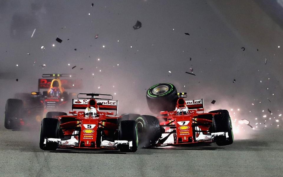 Sebastian Vettel of Germany driving the (5) Scuderia Ferrari SF70H and Kimi Raikkonen of Finland driving the (7) Scuderia Ferrari SF70H collide at the start during the Formula One Grand Prix of Singapore at Marina Bay Street Circuit on September 17, 2017 in Singapore - Getty Images AsiaPac 