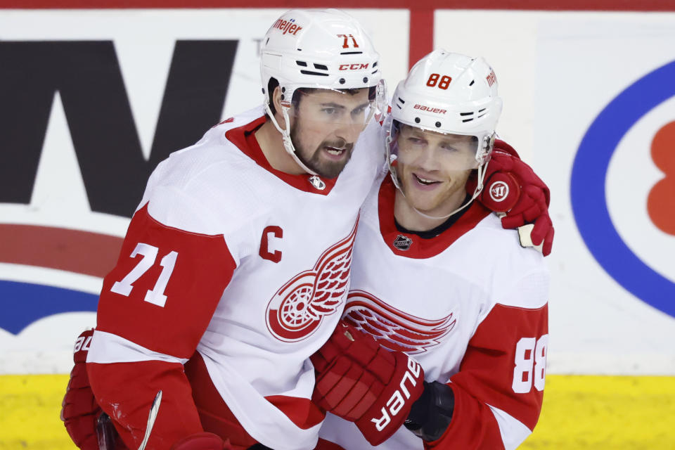 Detroit Red Wings centre Dylan Larkin (71) celebrates his goa' against the Calgary Flames with teammate Patrick Kane (88) during the second period of an NHL hockey game in Calgary, Alberta, Saturday, Feb. 17, 2024. (Larry MacDougal/The Canadian Press via AP)
