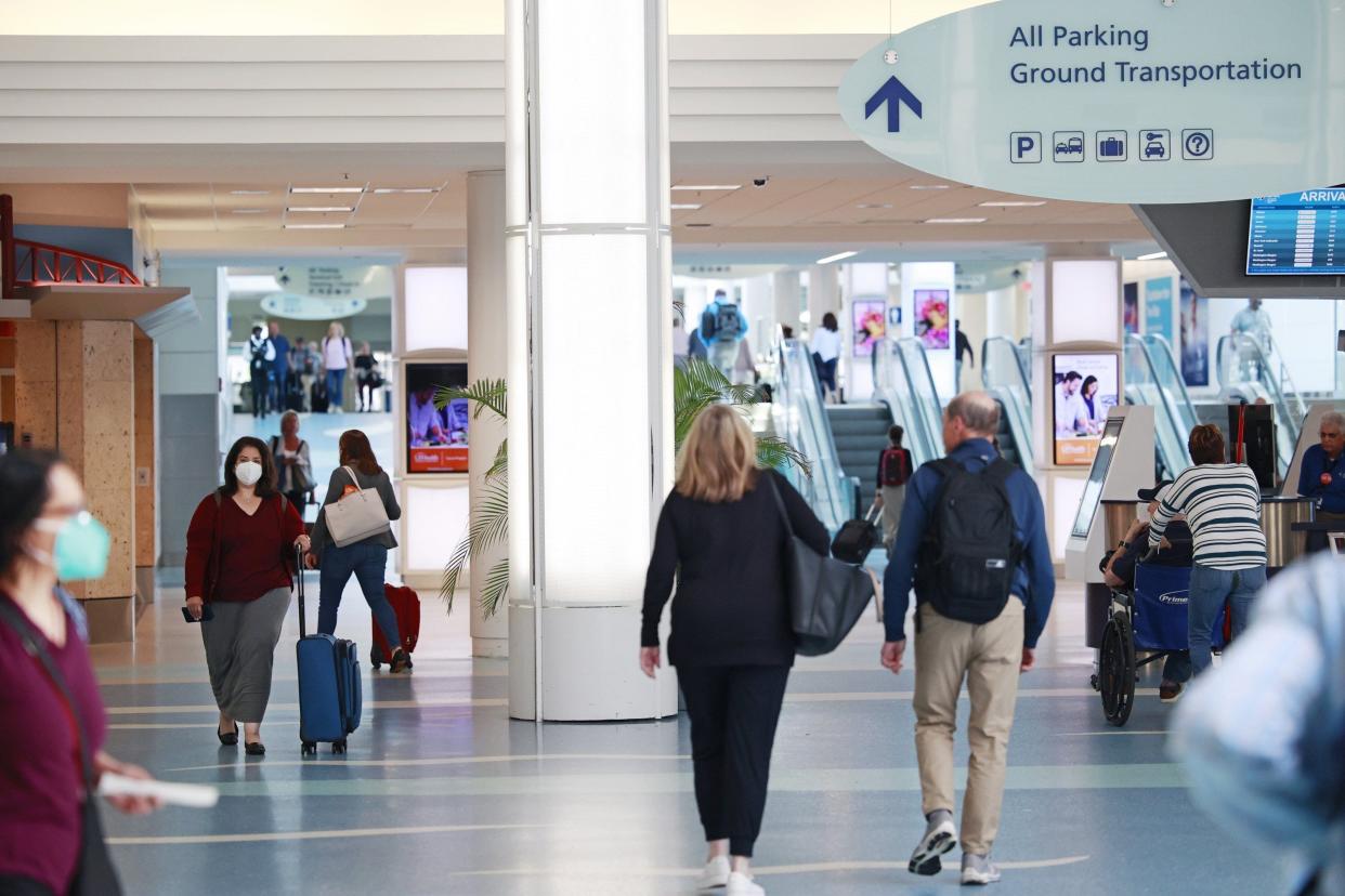 Travelers make their way to and from gates recently at Jacksonville International Airport in Jacksonville. With the coronavirus loosening its grip on the country and another holiday coming up for the Fourth of July, the expectations are for travel and tourism to increase.