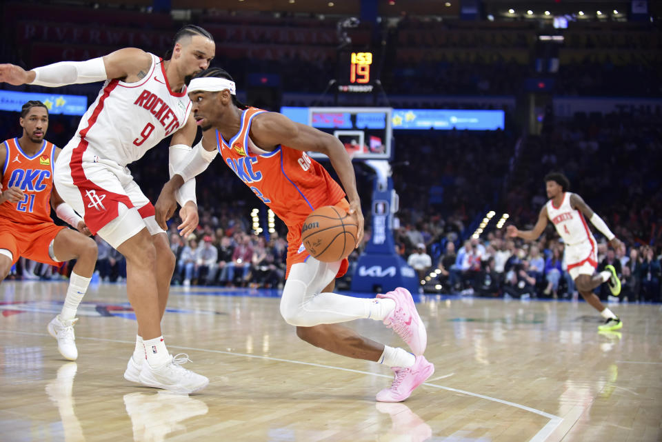 Oklahoma City Thunder guard Shai Gilgeous-Alexander, right, drives against Houston Rockets forward Dillon Brooks during the first half of an NBA basketball game Tuesday, Feb. 27, 2024, in Oklahoma City. (AP Photo/Kyle Phillips)