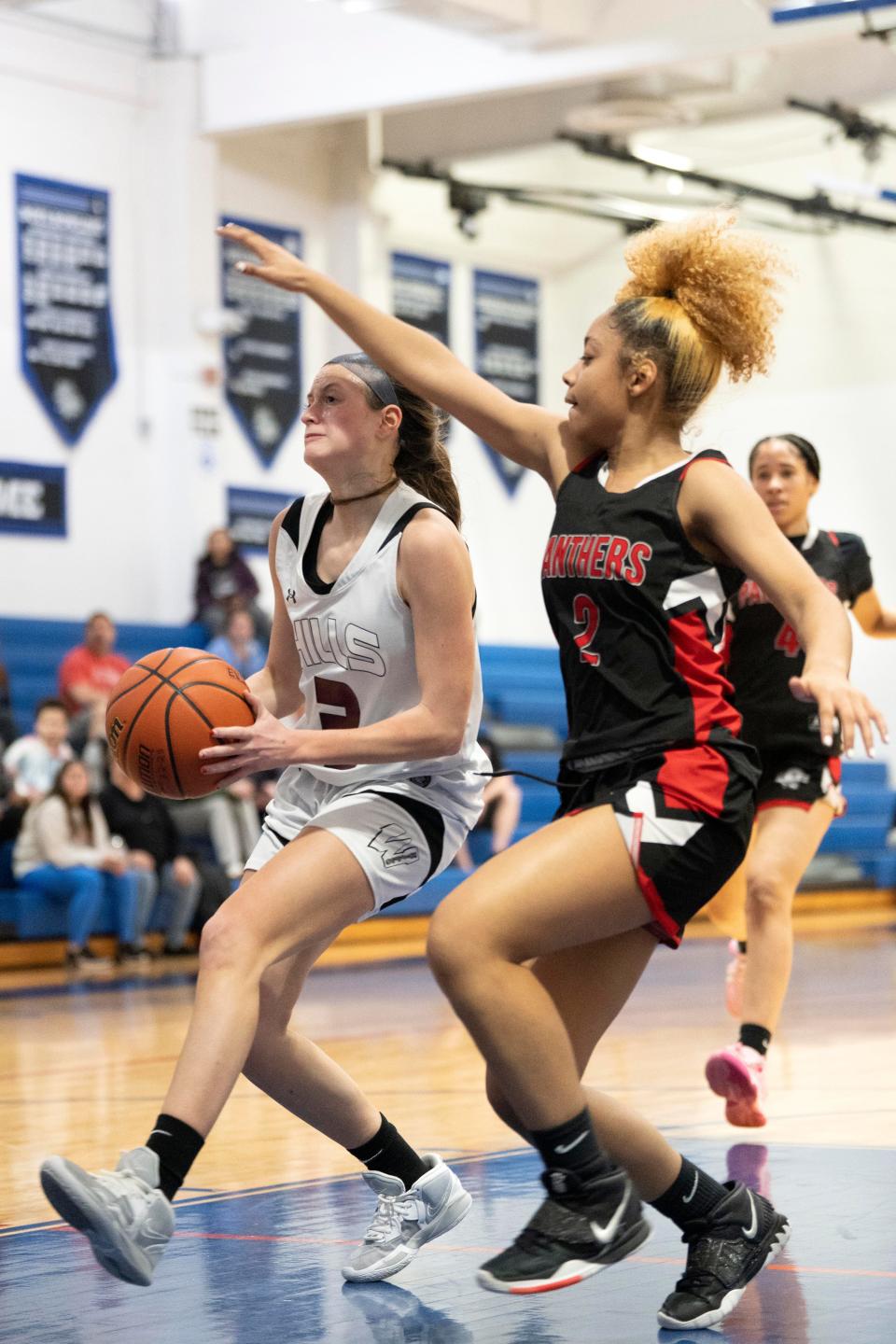 Passaic Charter vs. Wayne Hills in the Passaic County Girls Basketball semifinals at Passaic County Technical Institute in Wayne on Thursday, February 16, 2023.  WH #3 Lilly Weltyman drives to the basket as PC #2 Asoni Henderson defends.