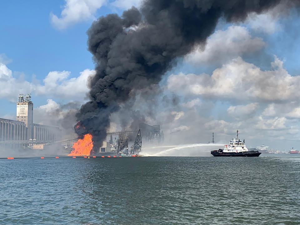 CORRECTS TO PROPANE PIPELINE INSTEAD OF A NATURAL GAS PIPELINE - In this photo released by the U.S. Coast Guard, Coast Guard crews respond to a dredge on fire in the Port of Corpus Christi Ship Channel, Aug. 21, 2020 in Corpus Christi, Texas. Authorities say several people have been hospitalized after an explosion at the Texas port when a dredging vessel hit a propane gas pipeline in the water. (U.S. Coast Guard via AP)