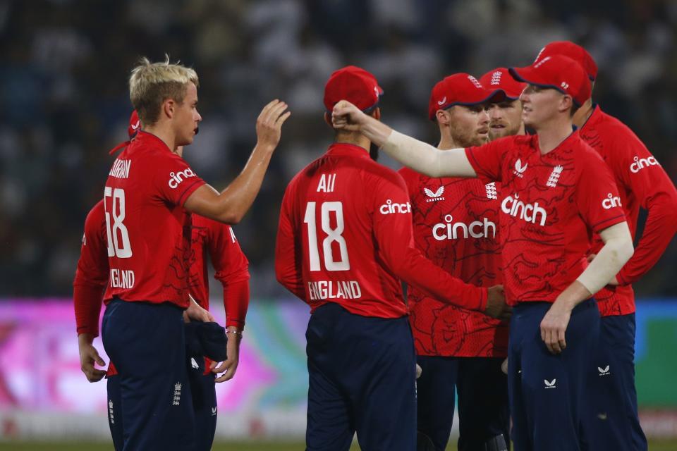 England's Sam Curran, left, celebrates with teammates after taking the wickets of Pakistan's Haider Ali during the sixth twenty20 cricket match between Pakistan and England, in Lahore, Pakistan, Friday, Sept. 30, 2022. (AP Photo/K.M. Chaudary)