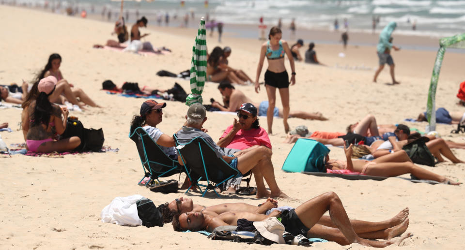 People sunbaking at Surfers Paradise beach on the Gold Coast . (AAP Image/Jason O&#xe2;&#x80;&#x99;Brien) NO ARCHIVING