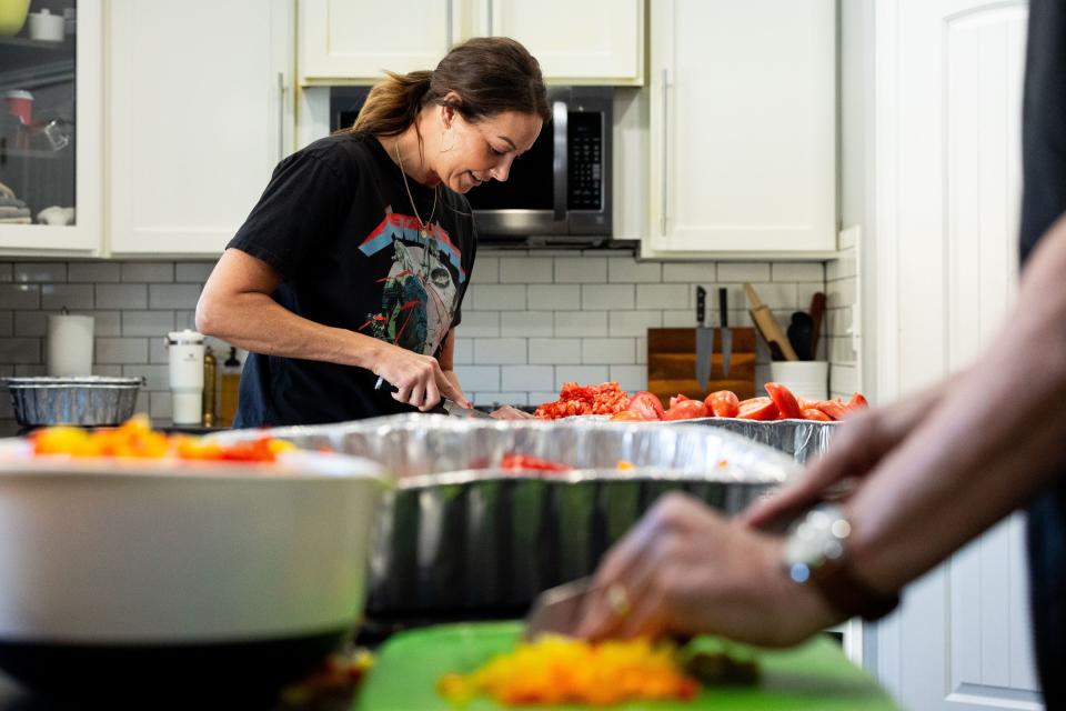 Jessica Lowe, founder of Be a Little Too Kind, dices tomatoes to make 100 plus portions of jambalaya at her home in Draper on Wednesday, Jan. 31, 2024. Be a Little Too Kind is a nonprofit organization focused on assisting homeless people by providing a homemade meal every week and other essential life sustaining items. | Megan Nielsen, Deseret News