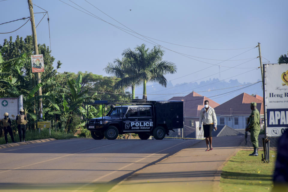 A police bomb squad vehicle secures a road leading to the scene of an explosion in the Komamboga suburb of the capital Kampala, Uganda Sunday, Oct. 24, 2021. Police said one person was killed and several others injured in the explosion late Saturday and that detectives would "determine whether the explosion arose from an intentional act or not." (AP Photo/Nicholas Bamulanzeki)