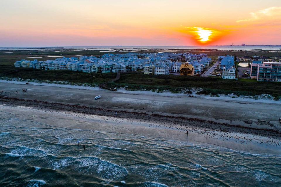 Sun rises above Crashing waves on Padre Island National Shoreline Beach near Port Aransas Texas