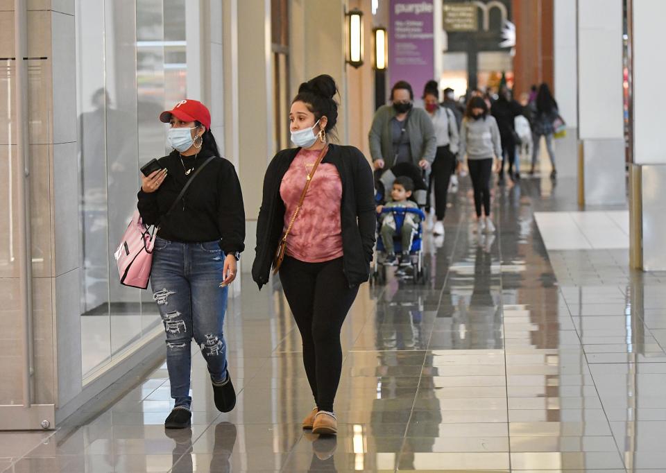 Shoppers walk through a mall in early November. Stores are expecting more Black Friday shoppers this year, but have also made deals available online and earlier.