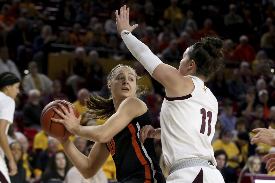 Oregon State's Mikayla Pivec (0) looks to pass against Arizona State's Robbi Ryan (11) during the first half of an NCAA college basketball game Sunday, Jan. 12, 2020, in Tempe, Ariz. (AP Photo/Darryl Webb)