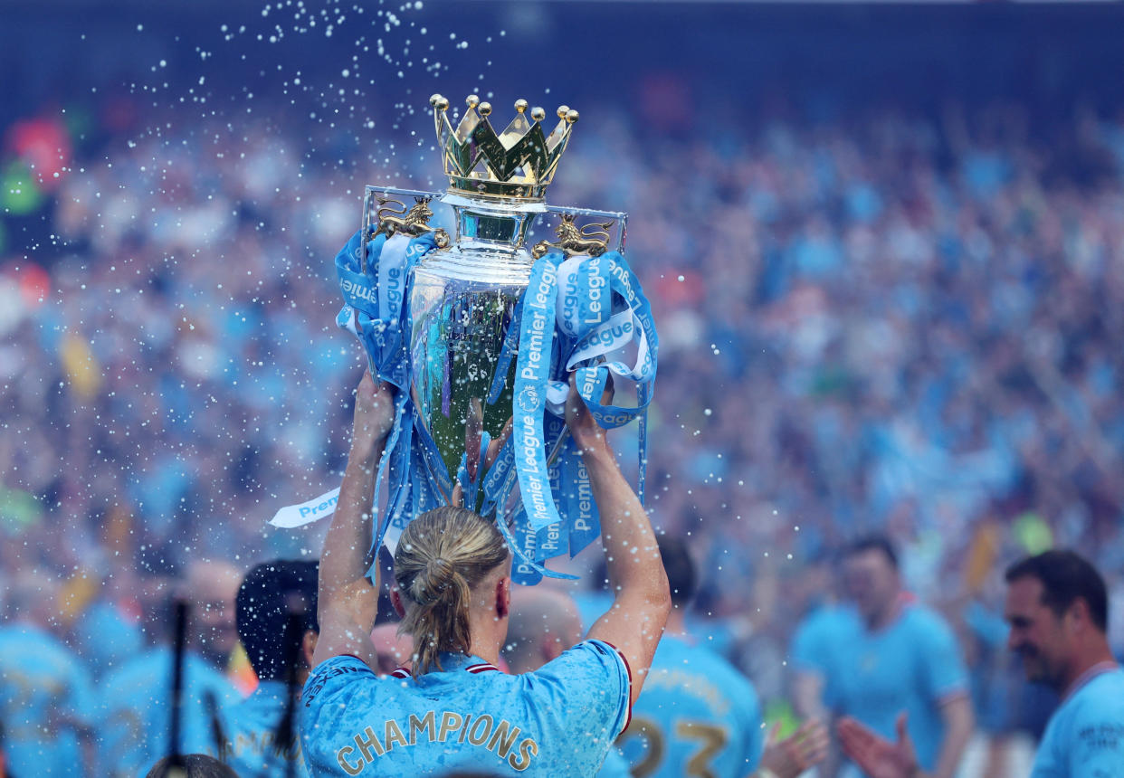 Manchester City's Erling Haaland celebrates with the English Premier League trophy. 