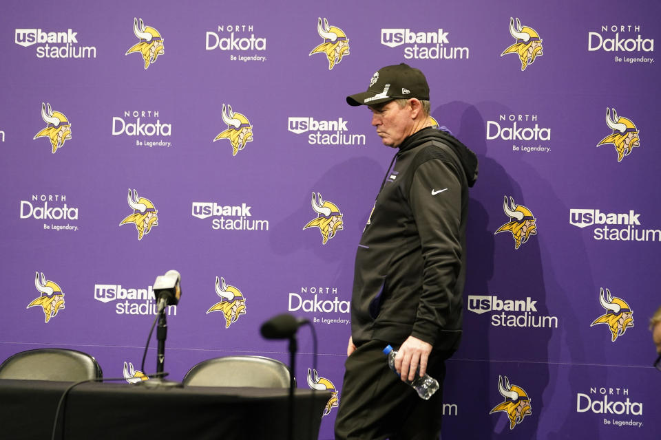 FILE - Minnesota Vikings head coach Mike Zimmer arrives at a news conference after an NFL football game against the Chicago Bears, Sunday, Jan. 9, 2022, in Minneapolis. The Vikings won 31-17. The Minnesota Vikings fired general manager Rick Spielman and head coach Mike Zimmer on Monday, Jan. 10, 2022, according to a person with knowledge of the decision, after a second straight absence from the playoffs. The person spoke on condition of anonymity because the Vikings had not yet made the announcement. (AP Photo/Jim Mone, File)