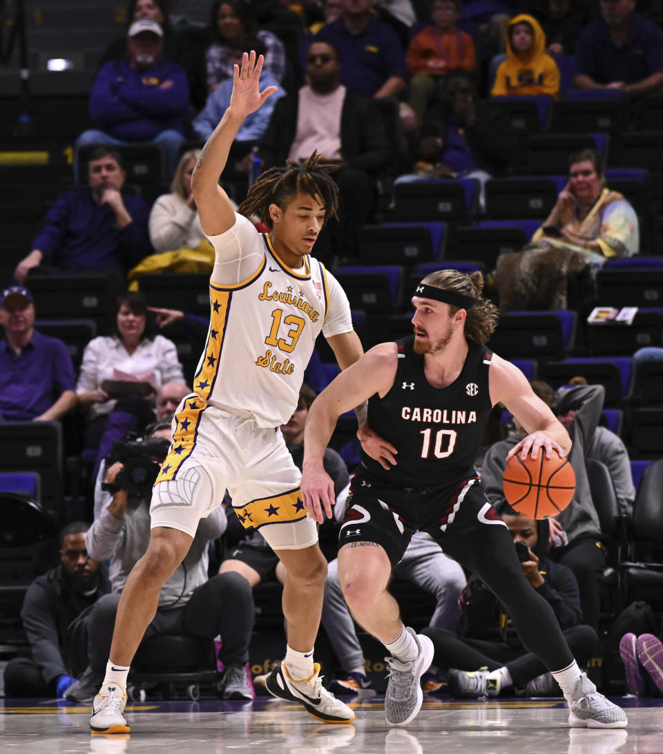 LSU forward Jalen Reed (13) defends as South Carolina forward Hayden Brown (10) works the ball inisde during an NCAA college basketball game, Saturday, Feb. 18, 2023, in Baton Rouge, La. (Hilary Scheinuk/The Advocate via AP)