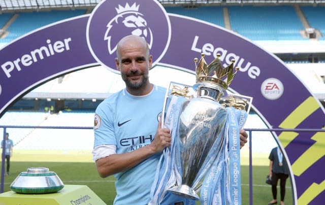 Manchester City manager Pep Guardiola lifts the Premier League trophy