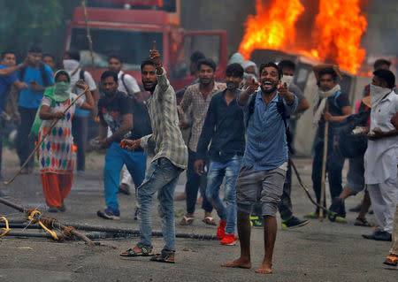 People react during violence in Panchkula, India, August 25, 2017. REUTERS/Cathal McNaughton