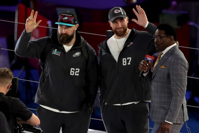 Jason Kelce #62 of the Philadelphia Eagles and Travis Kelce #87 of the Kansas City Chiefs wave onstage during Super Bowl LVII Opening Night