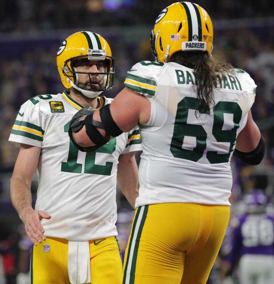 Green Bay Packers quarterback Aaron Rodgers (12) celebrates a touchdown by running back Aaron Jones (33) with offensive tackle David Bakhtiari (69) during the third quarter of their game Monday, December 23, 2019 at US Bank Stadium in Minneapolis, Minn. The Green Bay Packers beat the Minnesota Vikings 23-10.