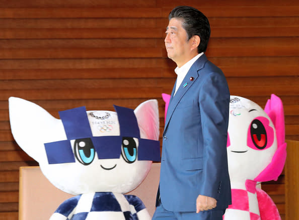 Prime Minister of Japan Shinzo Abe walks past soft toys of the Tokyo 2020 Olympic and Paralympic Games mascots Miraitowa and Someity as he leaves the official residence to inspect Fukui Prefecture on August 27, 2018 in Tokyo, Japan. (Photo by The Asahi Shimbun via Getty Images)