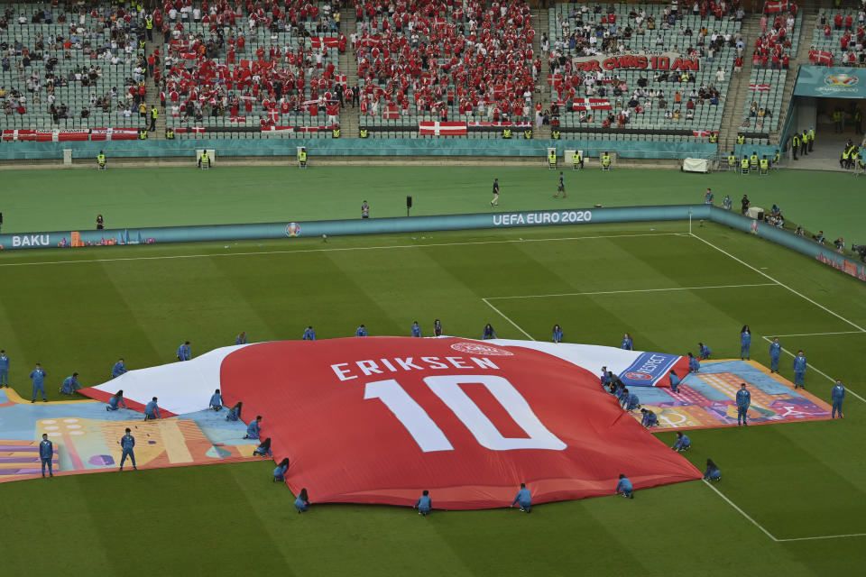 A giant shirt of Denmark's Christian Eriksen is displayed as a tribute before during the Euro 2020 soccer championship group quarterfinal match between the Czech Republic and Denmark at the Baku Olympic Stadium in Baku, Azerbaijan. (Dan Mullan, Pool Photo via AP)