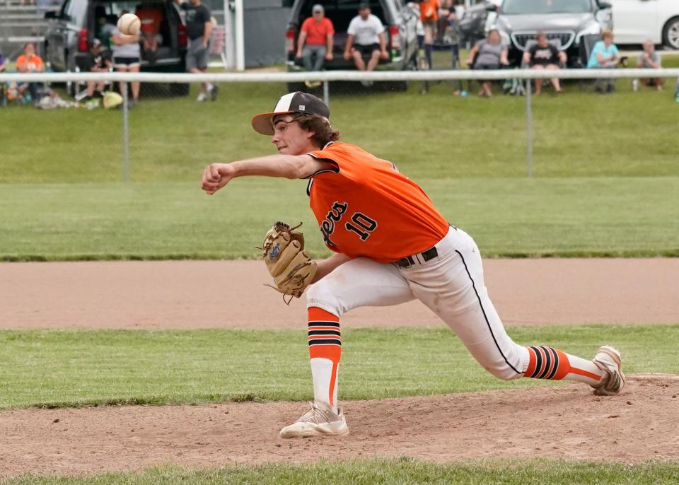 Hudson's Ambrose Horwath delivers a pitch during the Division 3 MHSAA district championship game against Hillsdale at home on Saturday.