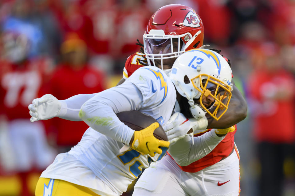 Los Angeles Chargers wide receiver Keenan Allen (13) is tackled by Kansas City Chiefs linebacker Nick Bolton (32) during the second half of an NFL football game, Sunday, Oct. 22, 2023 in Kansas City, Mo. (AP Photo/Reed Hoffmann)