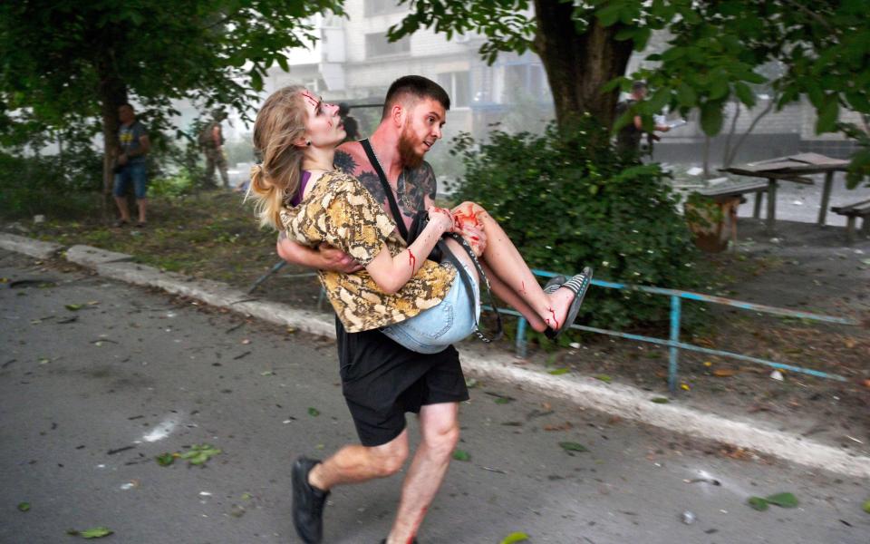 A man carries an injured Ukrainian woman after an explosion of a second rocket in the city of Pokrovsk, Donetsk area, Ukraine, 07 August 2023