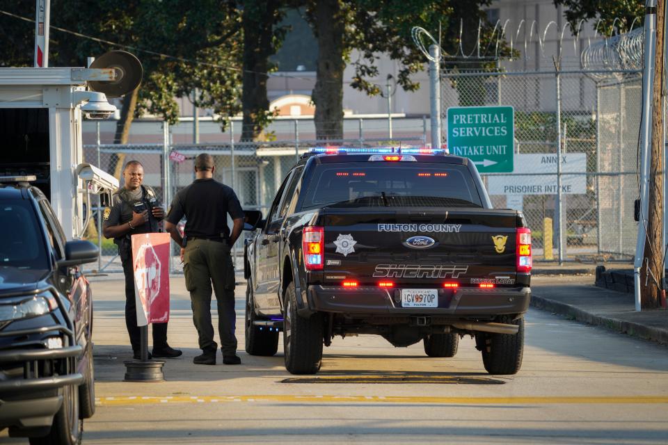 Law enforcement personnel work outside the Fulton County Jail Intake Center in Atlanta on Monday, Aug. 21, 2023.  Former president Donald Trump and 18 codefendants are expected to be arraigned in Fulton County, Ga. by Friday, Aug. 25.  Trump, his former attorney Rudy Guiliani and former White House Chief of Staff Mark Meadows were indicted along with other codefendants in a Georgia grand jury case related to 2020 election interference.