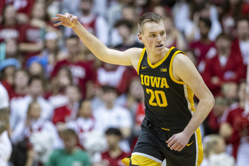 Iowa forward Payton Sandfort reacts after scoring a 3-point basket against Indiana during the second half of an NCAA college basketball game Tuesday, Feb. 28, 2023, in Bloomington, Ind. (AP Photo/Doug McSchooler)